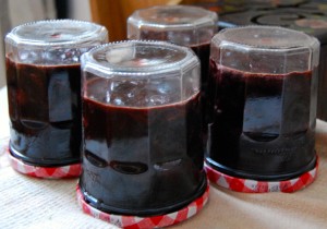 with cherry jam filled jars cooling down